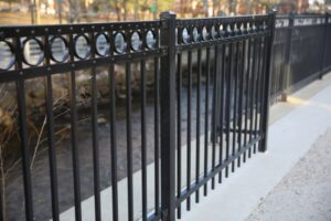 Enhance Security with a Black Metal Fence, Adorned with Iron Handrails and Railings