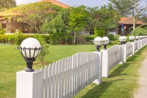 Add Elegance to Your Garden with a White Lamp on the Estate Fence