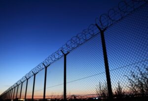 Capture Restricted Access in A Photo of A Razor Wire-Fortified Fence